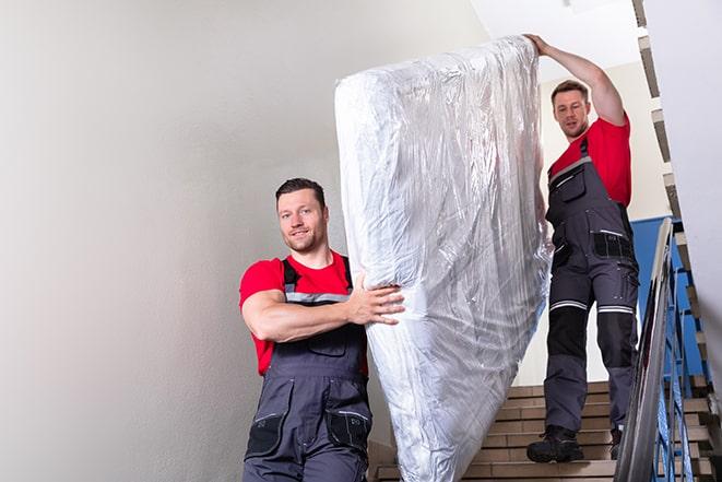 a box spring being taken out of a shipping box in East Berlin